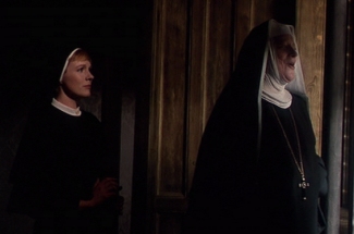 The mother abbess sings 'Climb Every Mountain'