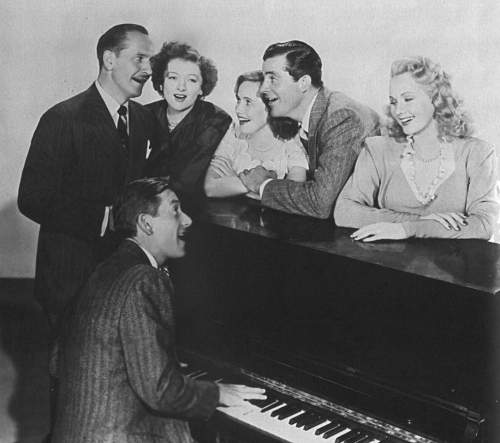 Carmichael plays the piano for the cast members