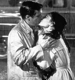 Paul and Holly kiss in the rain.